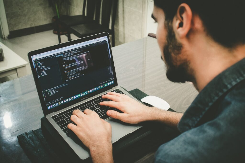 man computer programming on a laptop