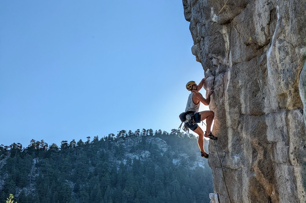 man rock climbing near boulder